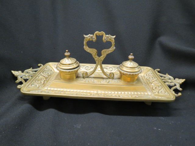 Appraisal: Brass Inkstand gryphon center handle double well rococo design footed