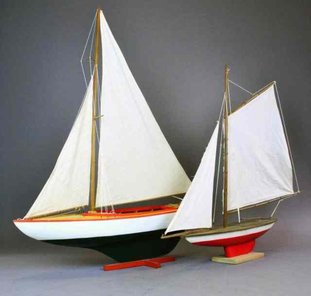 Appraisal: AMERICAN POND BOATS ON STANDSTo include a red white sailboat