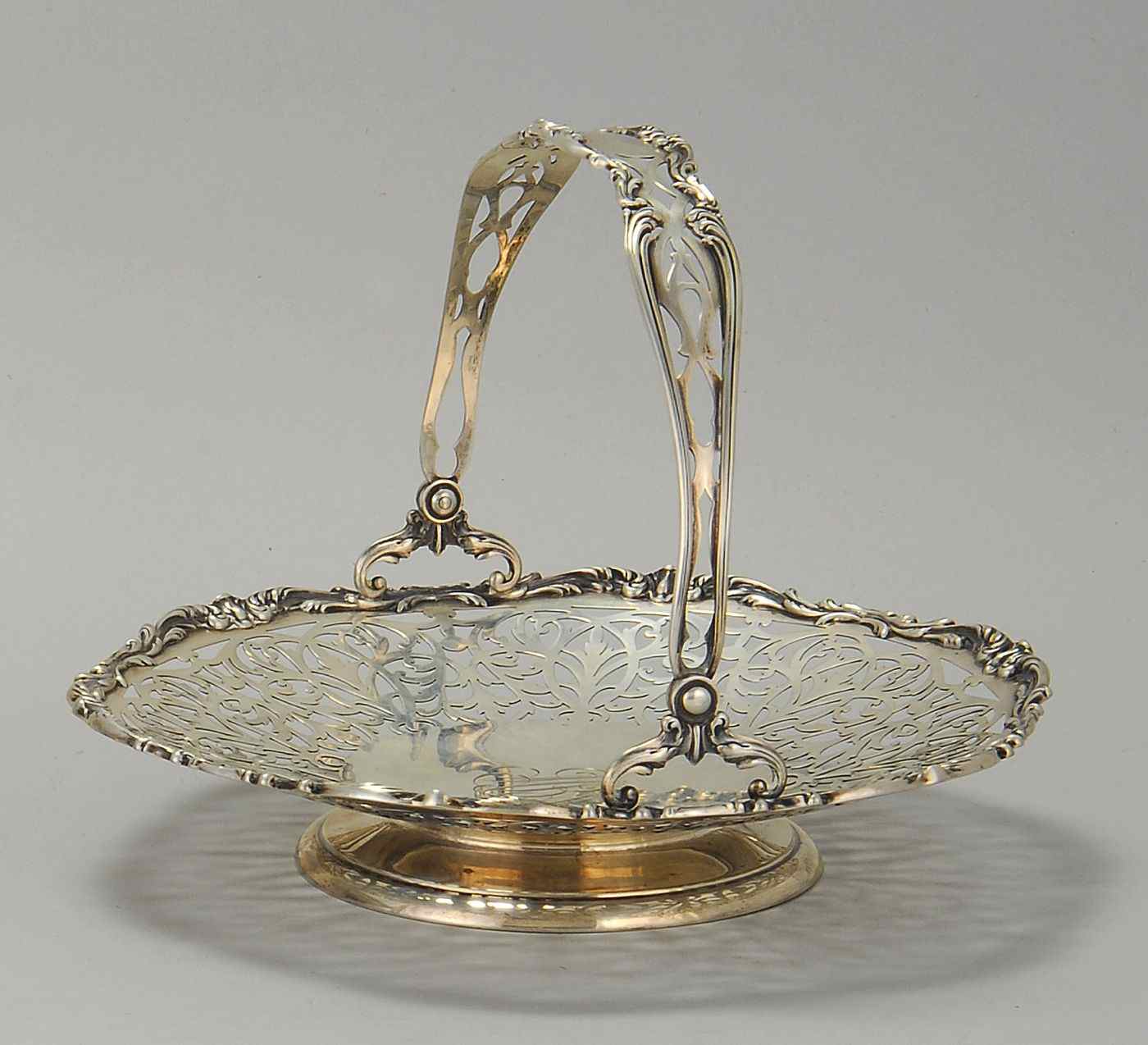 Appraisal: REED BARTON STERLING SILVER HANDLED BASKETWith reticulated sides Overall height