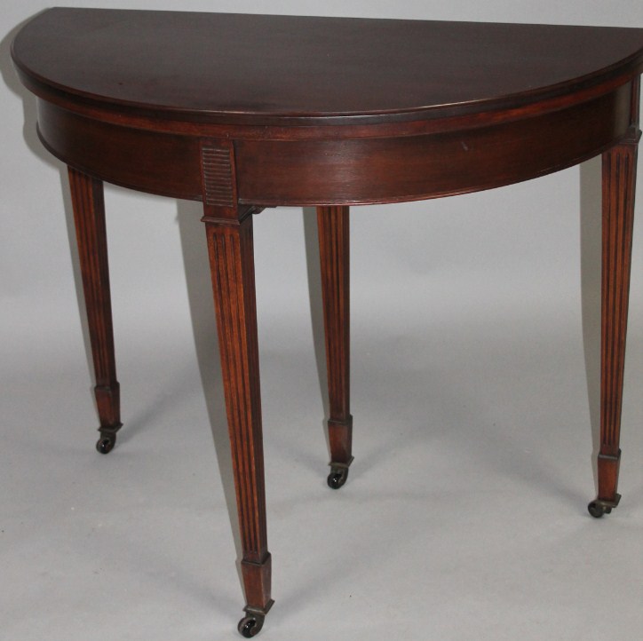 Appraisal: An Edwardian style mahogany fold over games table with D-end