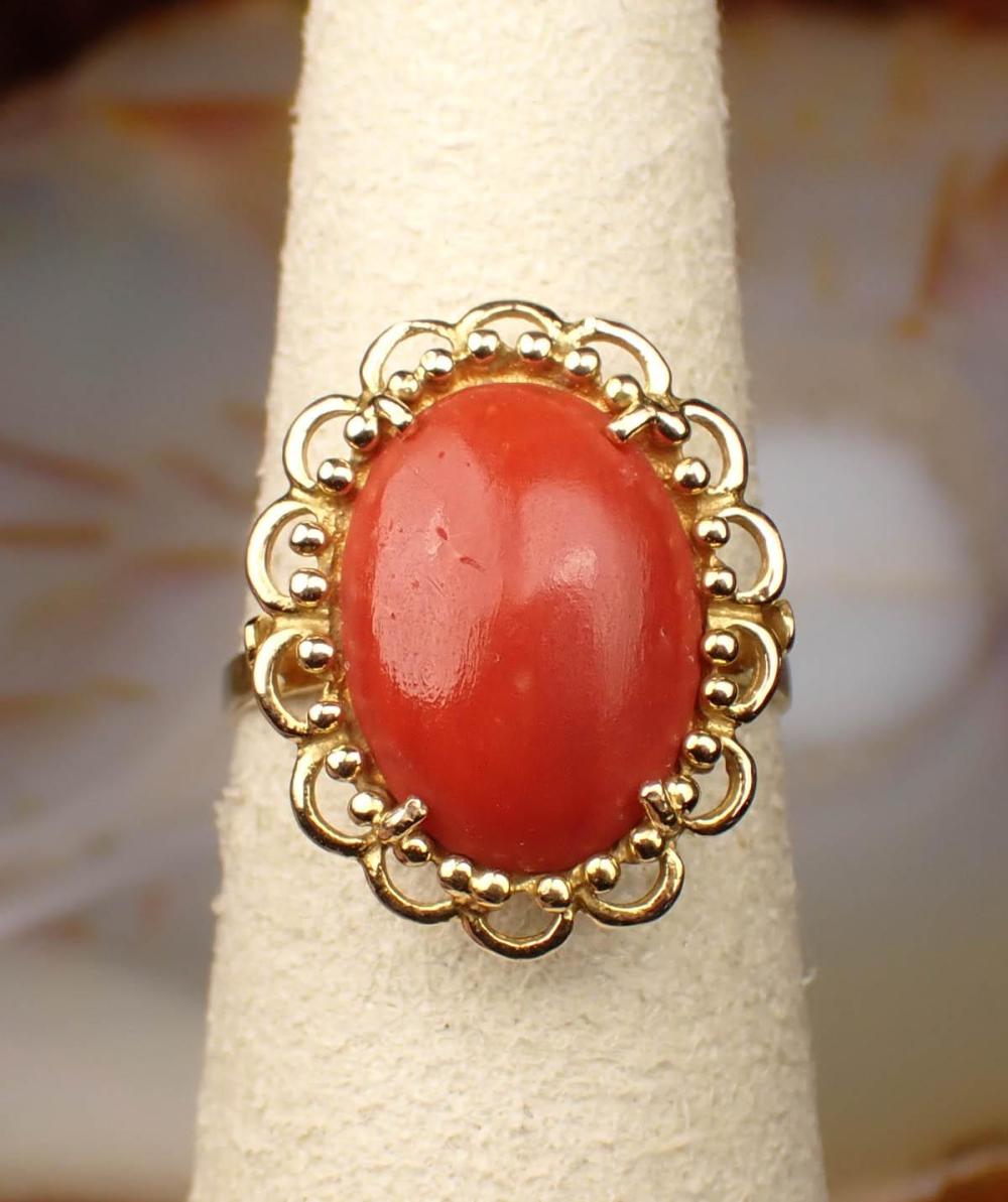 Appraisal: CORAL AND EIGHTEEN KARAT YELLOW GOLD RING set with an