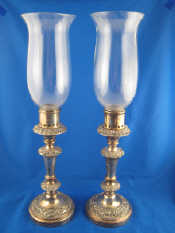 Appraisal: A pair of Old Sheffield Plate candlesticks with storm shades