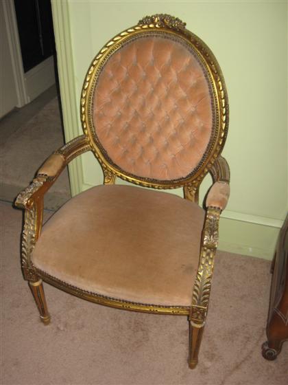 Appraisal: Pair of Louis XVI style giltwood fauteuilsOval tufted back and