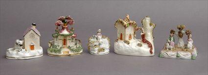 Appraisal: THREE STAFFORDSHIRE COTTAGES AND TWO FIGURE GROUPS One flanked by