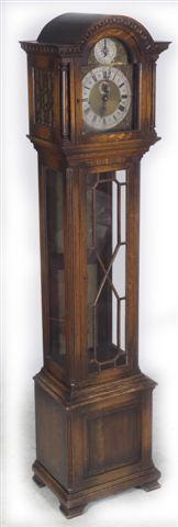 Appraisal: GEORGE III STYLE OAK LONGCASE CLOCK the arch-top hood carved