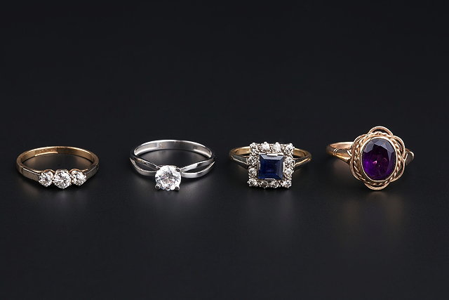 Appraisal: FOUR GEM SET DRESS RINGS comprising a sapphire and diamond