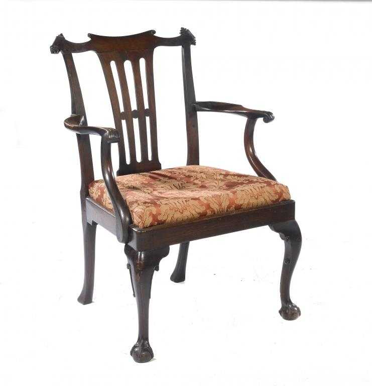 Appraisal: A MAHOGANY ELBOW CHAIR the crest rail with volute ears