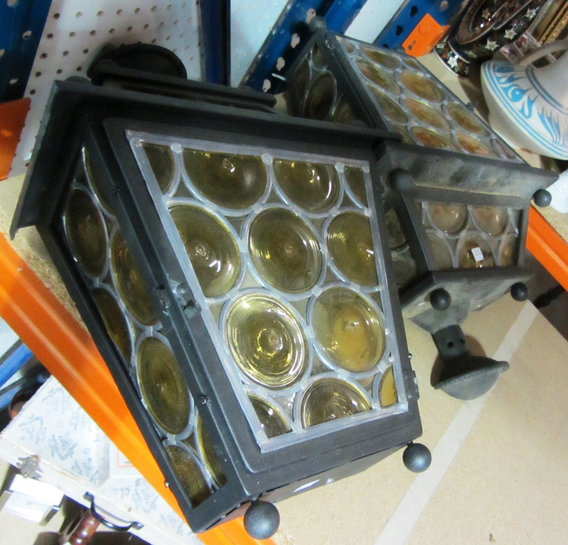 Appraisal: A pair of iron and yellow glass wall lanterns