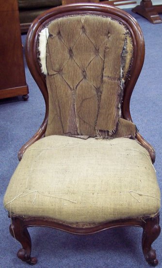 Appraisal: A Victorian upholstered chair with buttoned spoon back on front