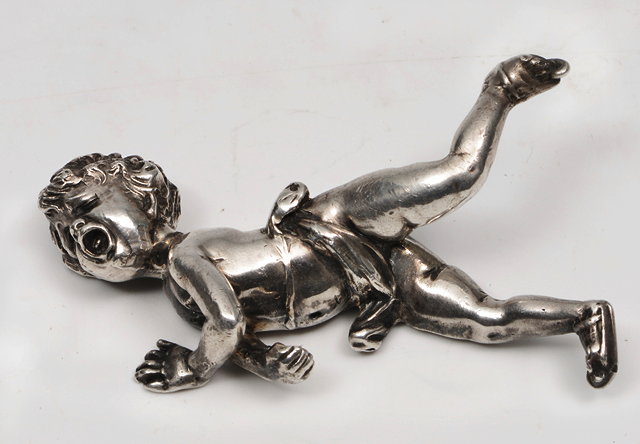 Appraisal: AN ANTIQUE CAST WHITE METAL FIGURE OF CUPID having fallen