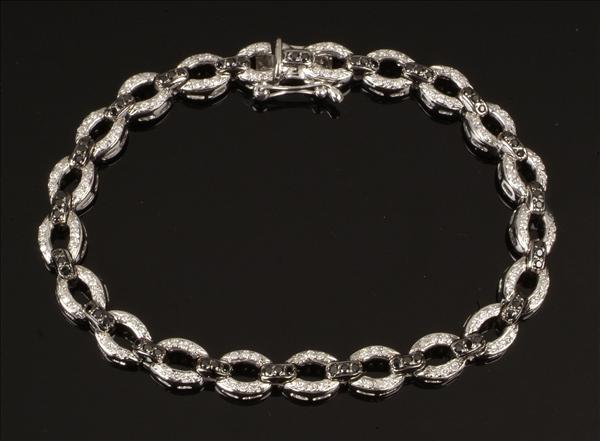 Appraisal: A diamond and black diamond bracelet the oval links pave