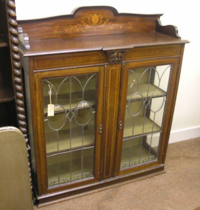 Appraisal: A late Victorian inlaid mahogany display cabinet raised back above