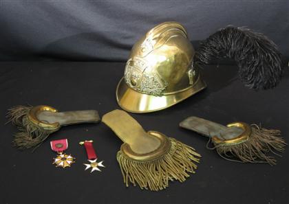 Appraisal: Three epaulets and brass parade helmet together with two American