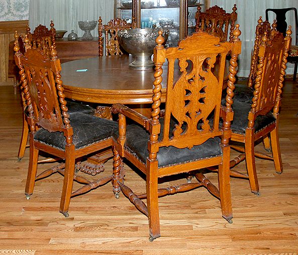 Appraisal: Set of Heavily Carved Oak Chairs A set of eight