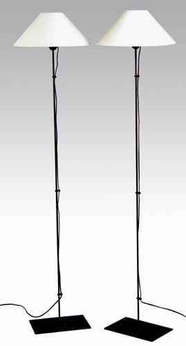 Appraisal: CHRISTIAN LIAGRE Pair of single-socket patinated metal floor lamps with