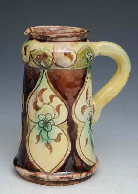 Appraisal: A Della Robbia art pottery jug with incised floral motif