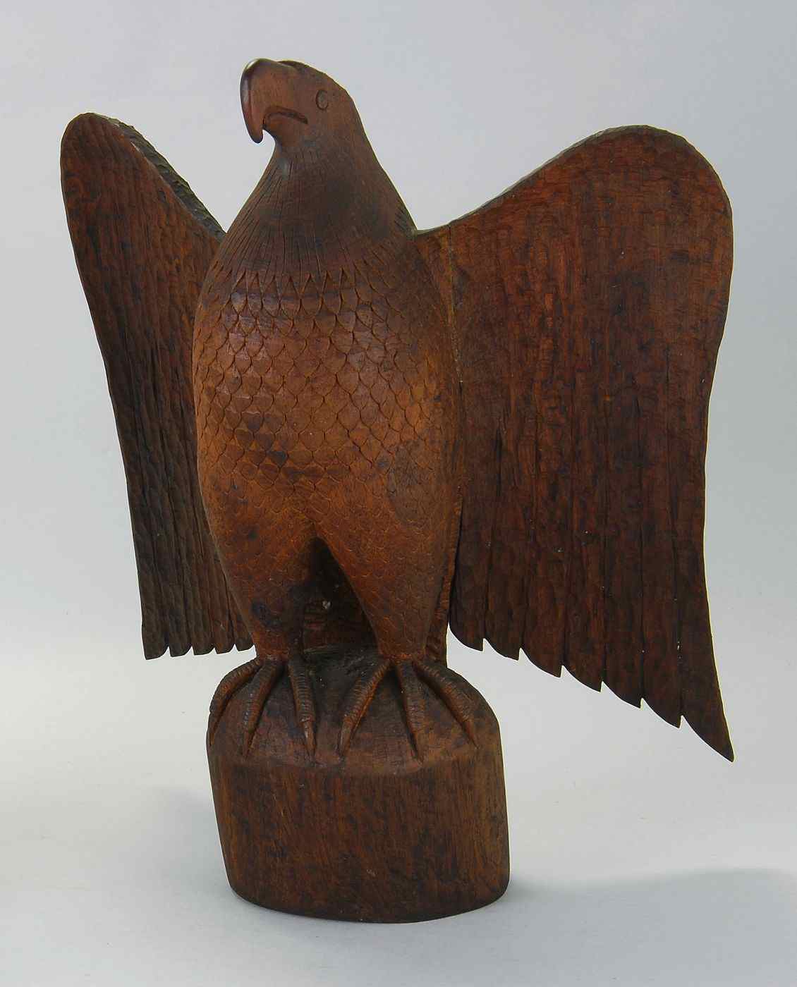 Appraisal: CARVED WOODEN EAGLE th CenturyWith chip-carved wings Mounted on a