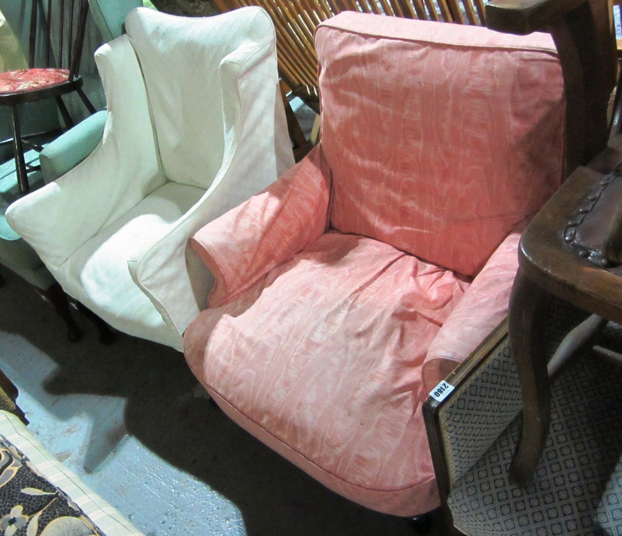 Appraisal: A pink upholstered armchair and a white upholstered chair