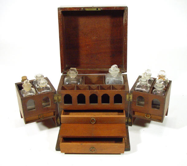 Appraisal: Mahogany cased apothecarys bottle set the hinged lid and doors