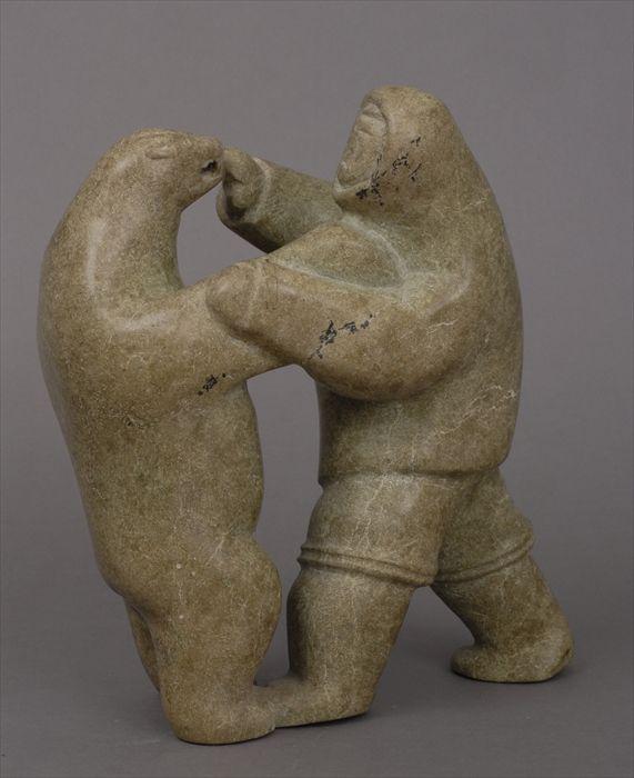 Appraisal: ESKIMO CARVED STONE GROUP Modeled as a man battling a