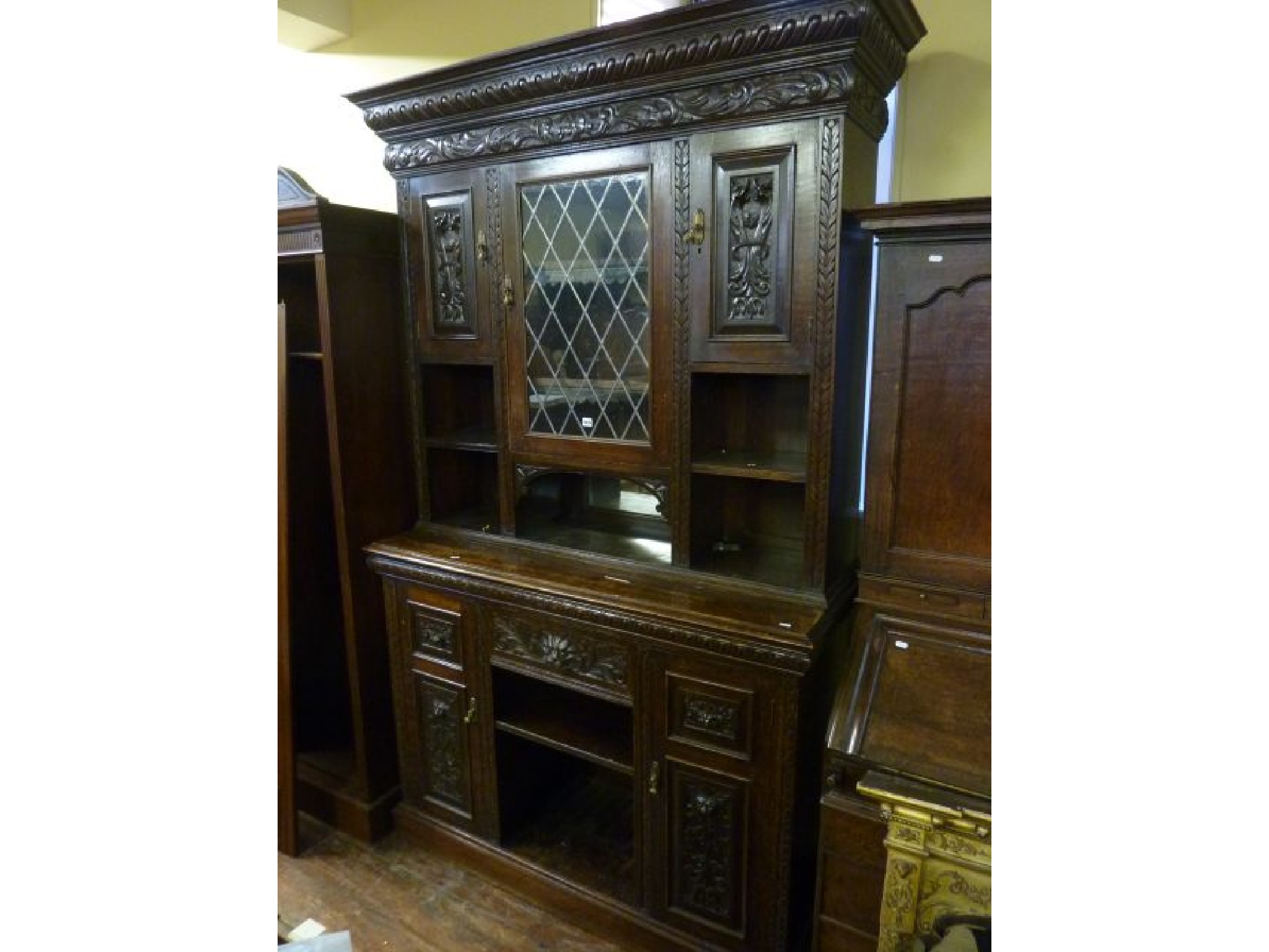 Appraisal: A substantial th century oak sideboard the lower section enclosed