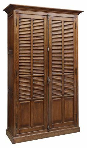 Appraisal: Oak library bookcase late th c molded cornice louver doors