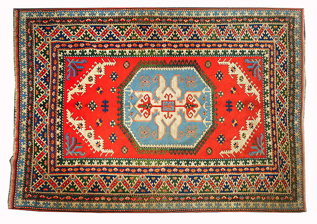 Appraisal: A TURKISH RED GROUND RUG with central octagonal geometric motif