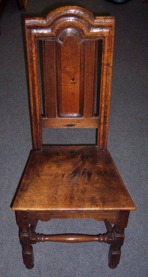 Appraisal: An oak chair of th Century design with arch panel