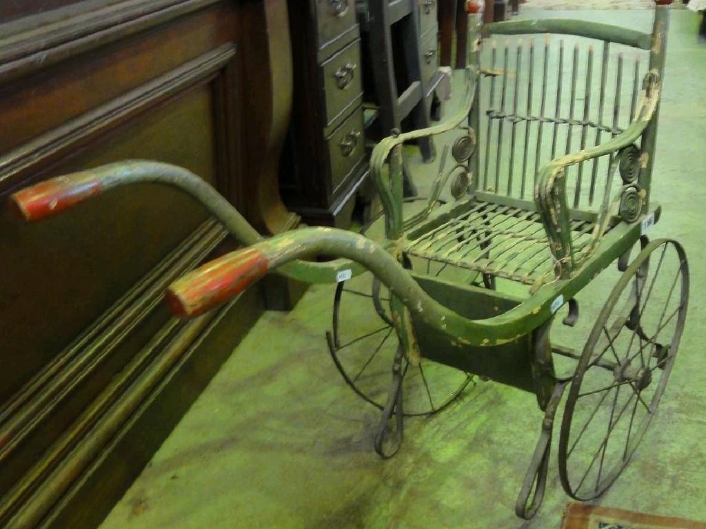 Appraisal: A Victorian child's carriage with shaped shafts simple woven stick