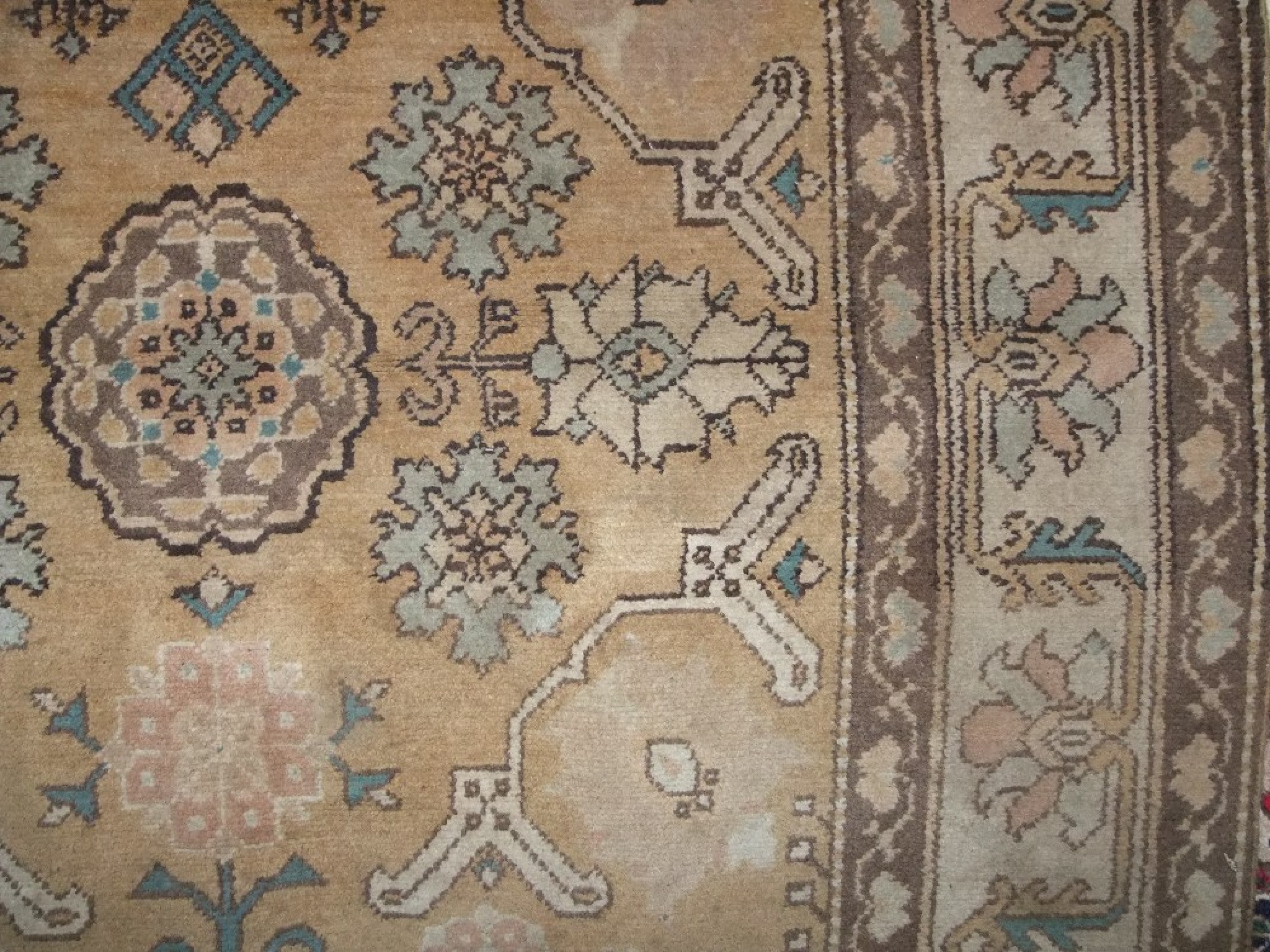 Appraisal: A Turkish wool rug with beige ground field and abstract