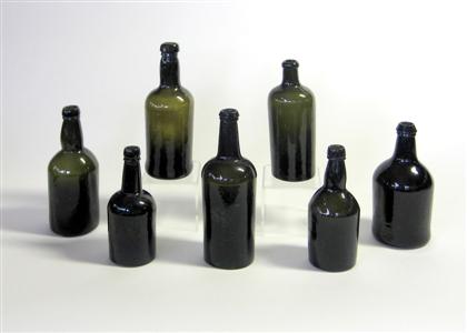 Appraisal: Seven blown green glass liquor bottles th th century H