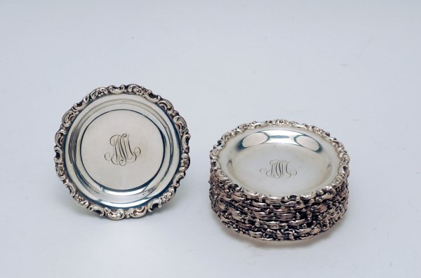 Appraisal: Twelve sterling silver butter pats scrolled edges monogrammed centers marked