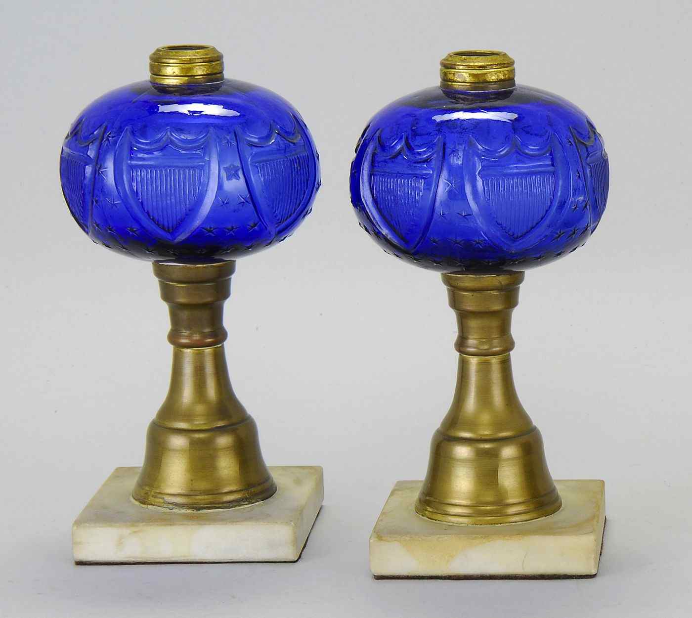 Appraisal: PAIR OF COBALT BLUE FLUID LAMPSLate th CenturyIn shield and