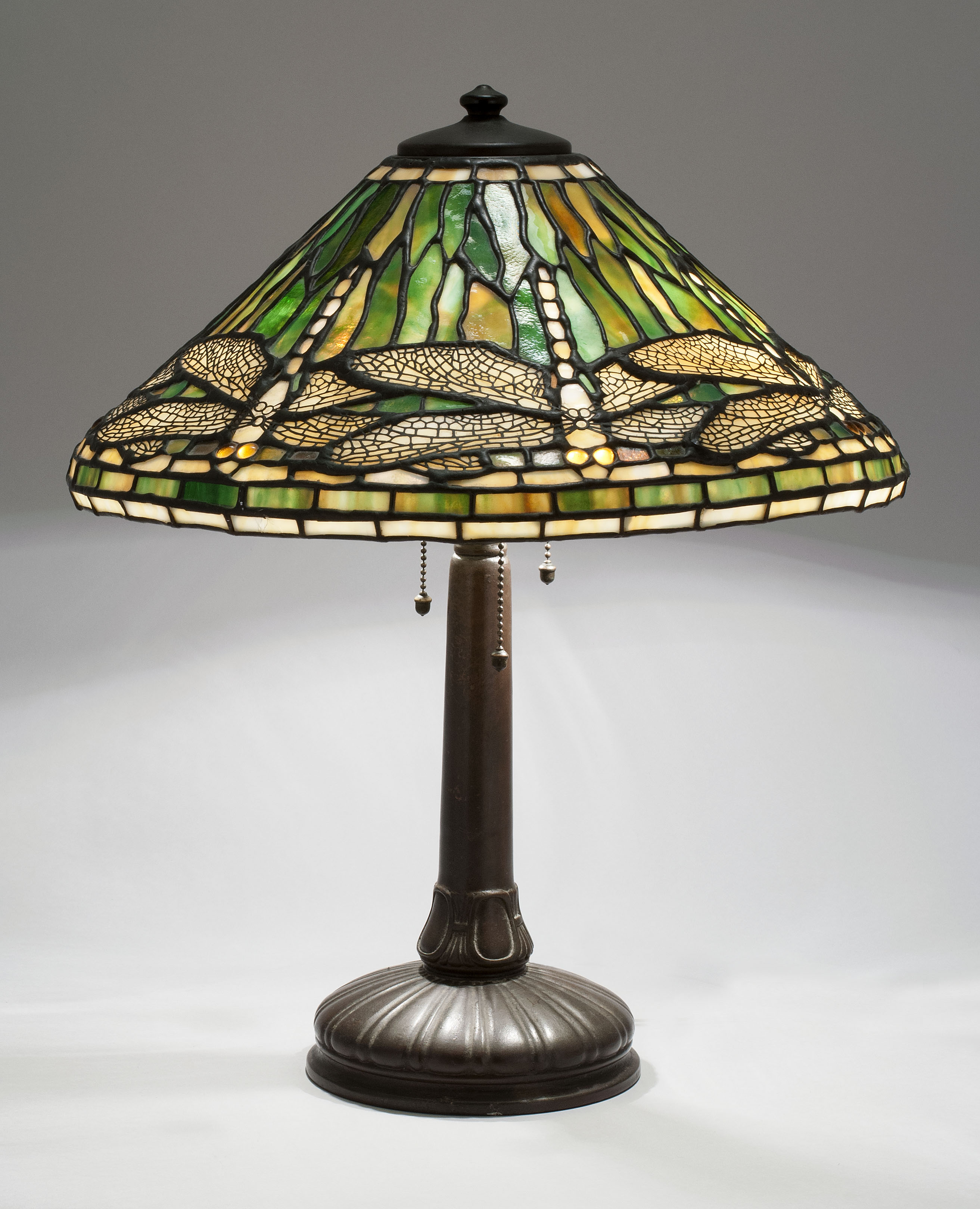 Appraisal: HANDEL BRONZE LAMP WITH LEADED GLASS SHADE Early th CenturyIn