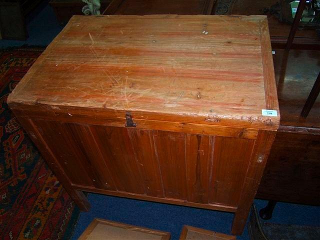 Appraisal: A pine box with panelled front and sides standing on