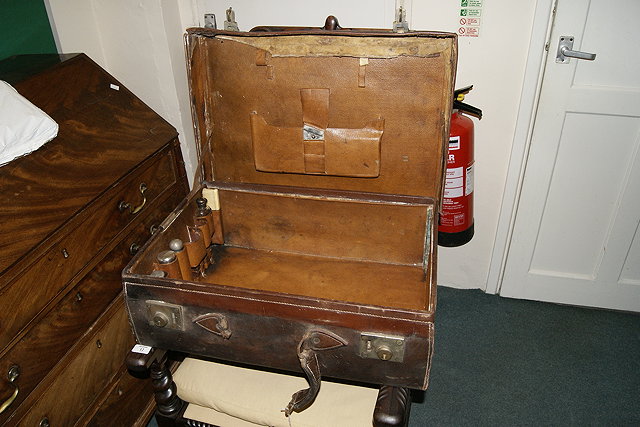 Appraisal: A LEATHER GENTLEMAN'S CASE with a few silver topped jars