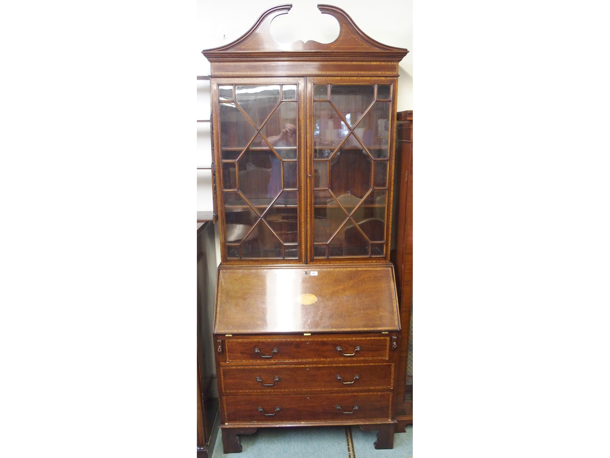 Appraisal: An Edwardian mahogany inlaid bureau bookcase x x cm