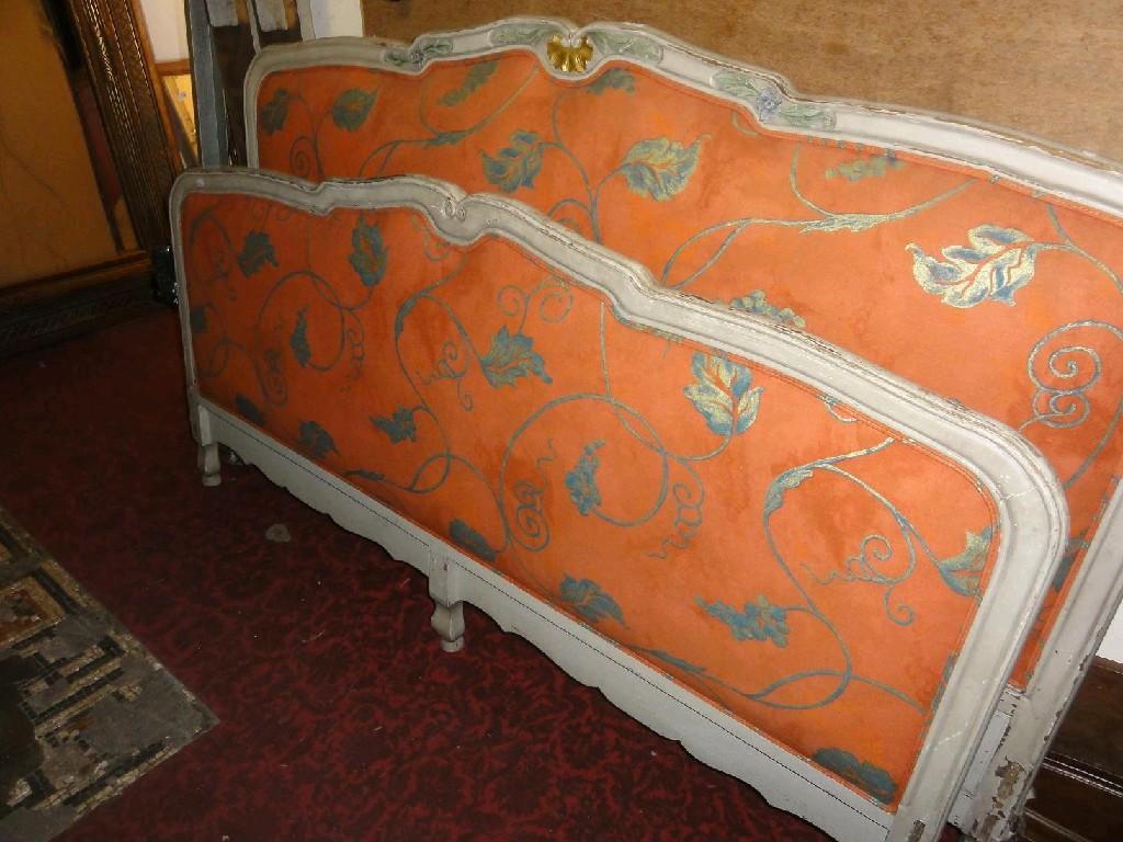 Appraisal: A continental double bedstead with floral upholstered panels within shaped