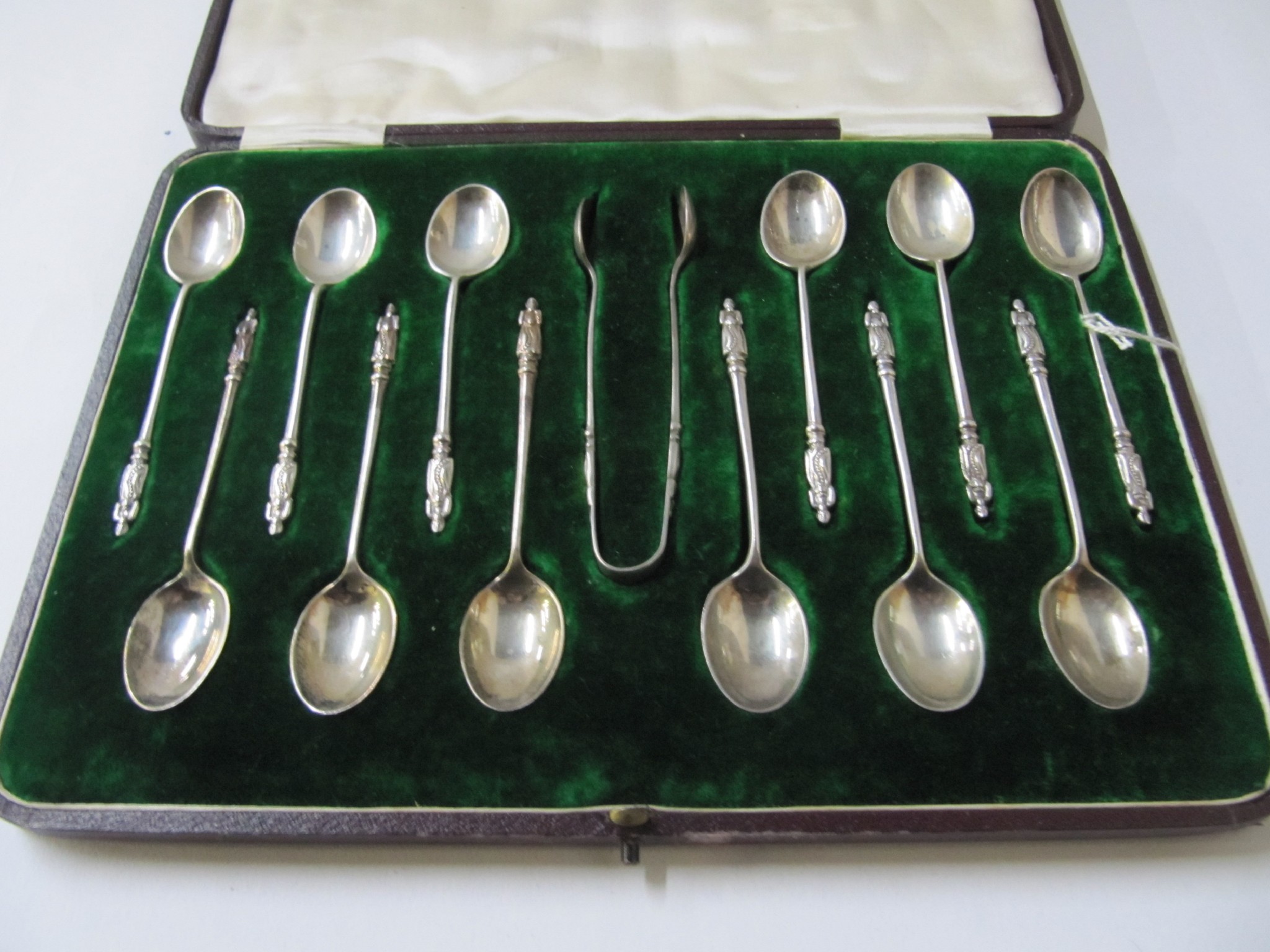 Appraisal: A cases set of silver teaspoons with tongs Sheffield