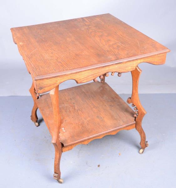 Appraisal: Parlor Table with Rolling Casters This wood parlor table has