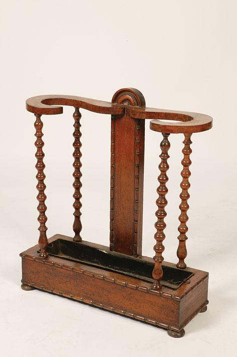 Appraisal: A REGENCY OAK STICK STAND with a scrolling top rail