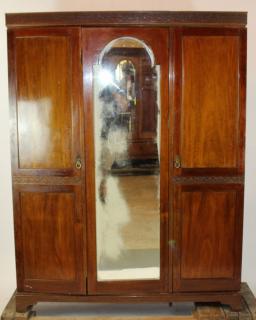 Appraisal: English mahogany triple armoire with center mirror h x w