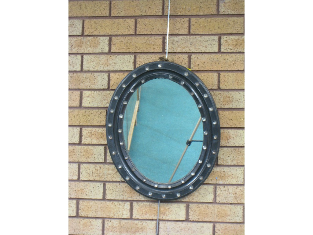 Appraisal: A Georgian Irish oval Wall Mirror the framed inset with