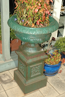 Appraisal: A PAIR OF REGENCY STYLE CAST IRON URNS ON PEDESTALS