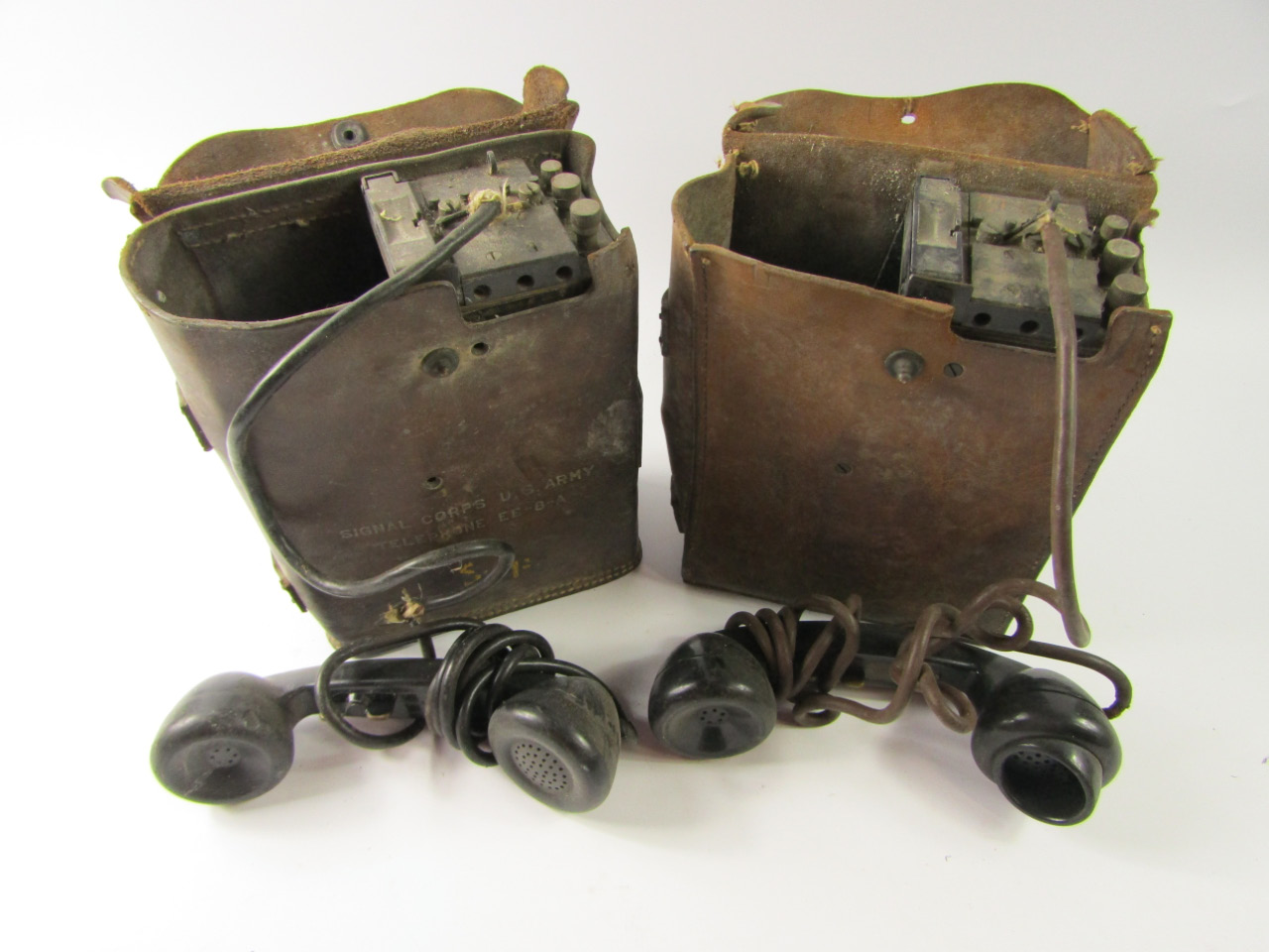 Appraisal: Two military field telephones leather cased one marked Signal Corps