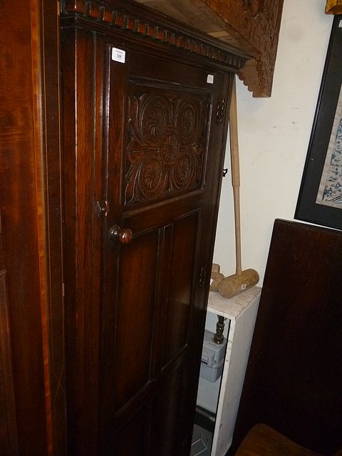 Appraisal: AN OAK HALL CUPBOARD with single panelled door standing on