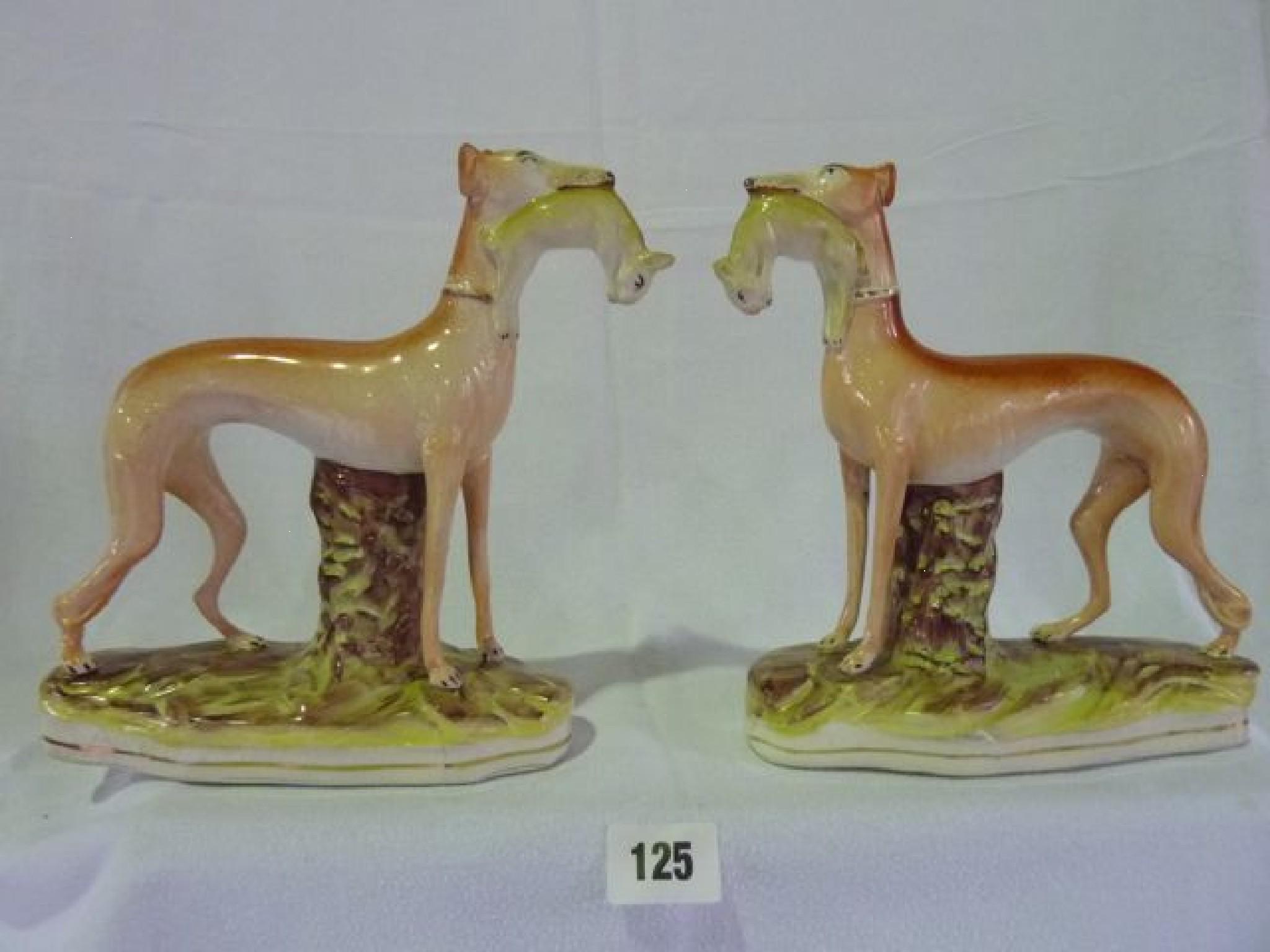 Appraisal: A pair of th century style Staffordshire figures of greyhounds