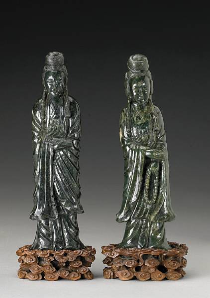 Appraisal: Two 'spinach' jade standing figures of Guanyin th Century Each