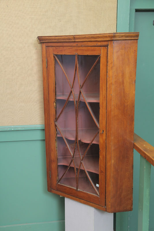 Appraisal: HANGING CORNER CUPBOARD Walnut having a glazed door with geometric