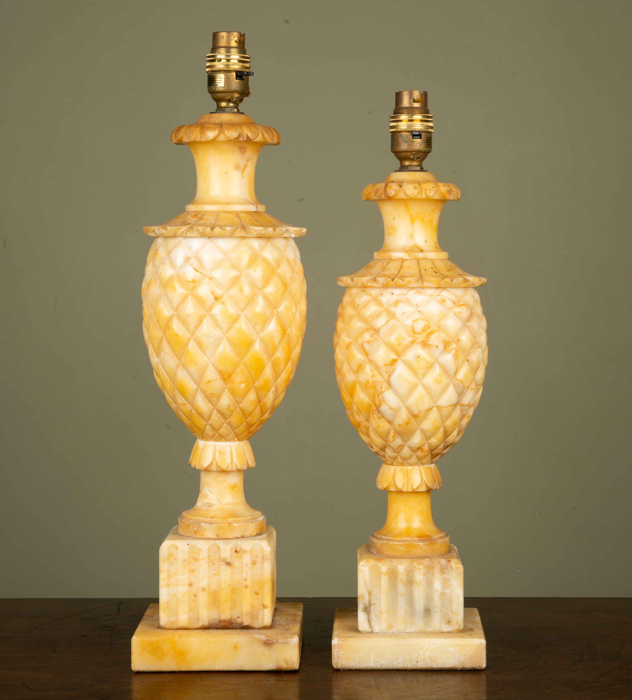 Appraisal: Two similar carved marble table lamps of pineapple form fluted